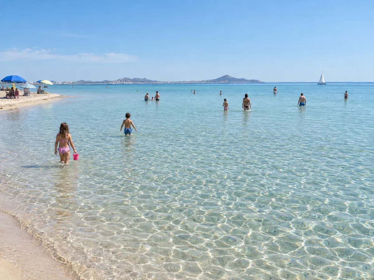 Children paddling in the calm, shallow water of the Mar Menor